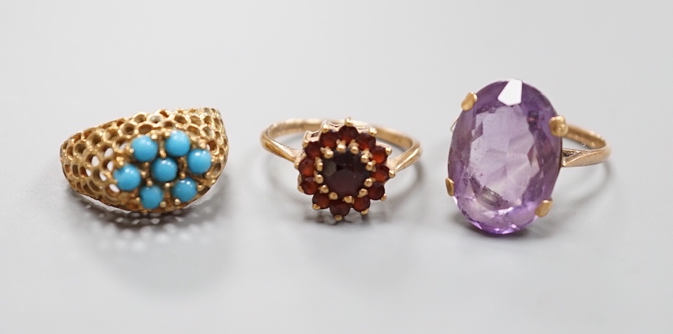 Three assorted modern 9ct gold dress rings including amethyst, garnet cluster and turquoise cluster, gross weight 11.1 grams.